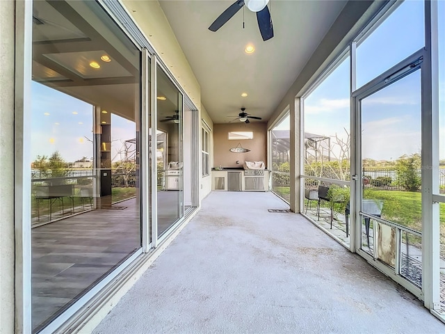 unfurnished sunroom featuring plenty of natural light and ceiling fan