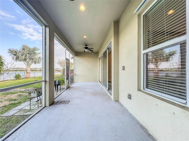 view of patio / terrace with a water view and ceiling fan