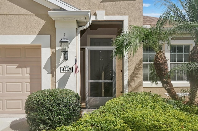 doorway to property with a garage