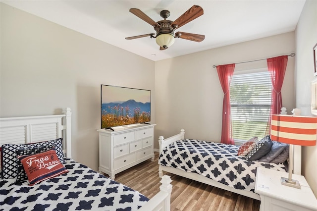 bedroom with ceiling fan and light hardwood / wood-style flooring