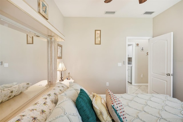 tiled bedroom featuring washer / dryer and ceiling fan