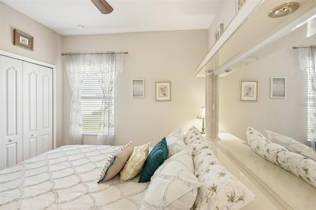 bedroom featuring ceiling fan and a closet