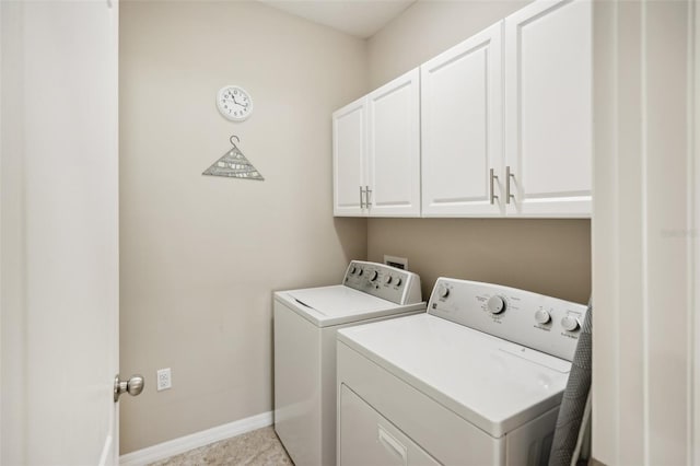 clothes washing area featuring cabinets, light tile patterned floors, and separate washer and dryer