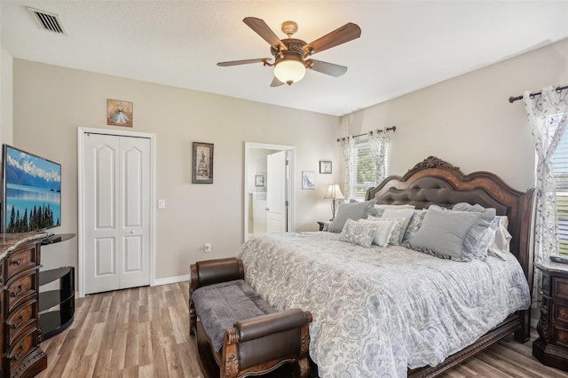 bedroom featuring light hardwood / wood-style flooring, ceiling fan, and a closet