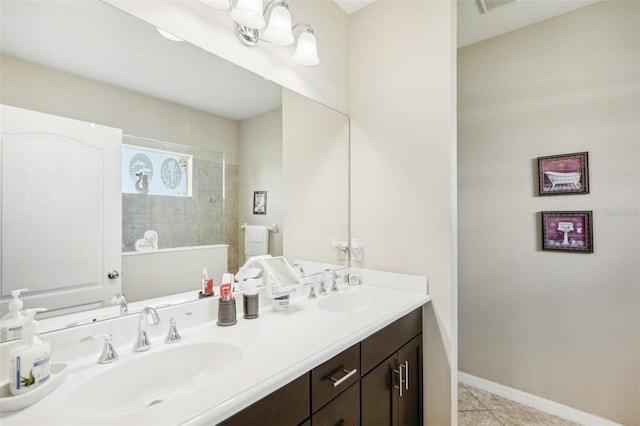 bathroom featuring vanity, tiled shower, and tile patterned floors