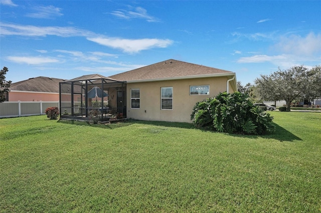 back of property with a lanai and a yard