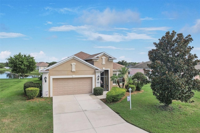 view of front of home featuring a garage, a front lawn, and a water view