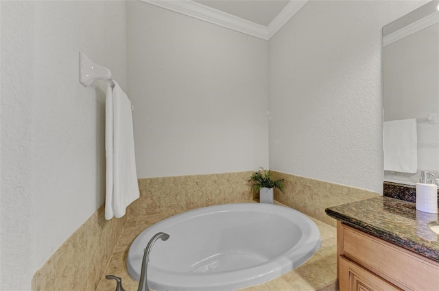 bathroom featuring tiled tub, vanity, and ornamental molding