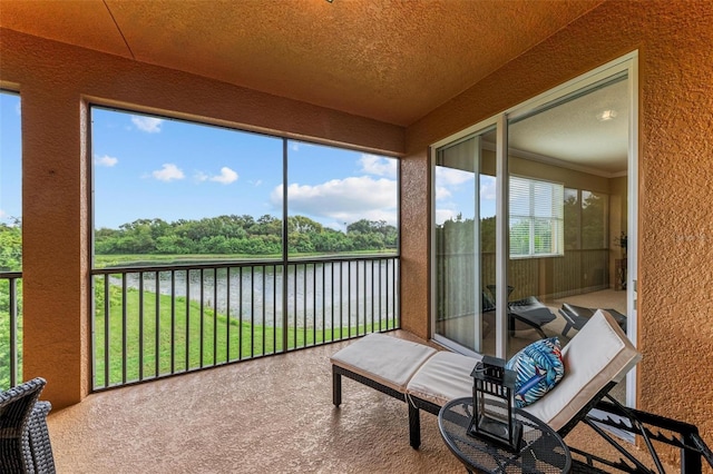 sunroom / solarium with a water view