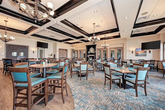 dining space with beamed ceiling, coffered ceiling, hardwood / wood-style floors, and a chandelier