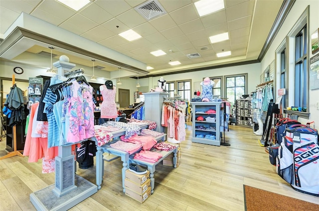 miscellaneous room with a drop ceiling and light hardwood / wood-style flooring