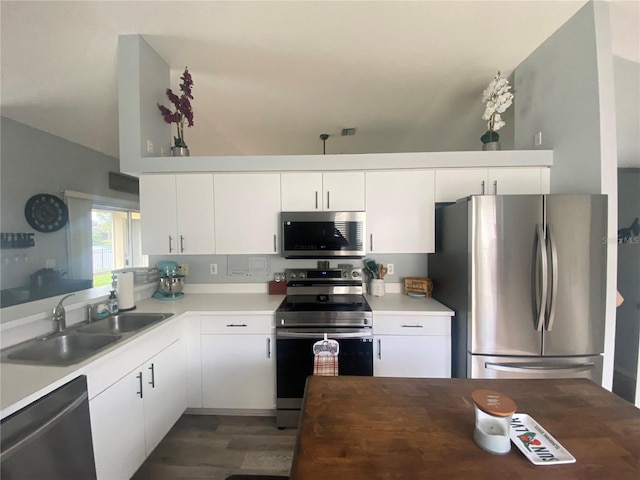 kitchen featuring white cabinetry, sink, dark wood-type flooring, and appliances with stainless steel finishes