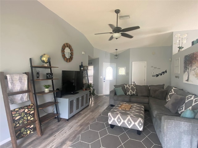 living room featuring dark hardwood / wood-style floors, ceiling fan, and vaulted ceiling