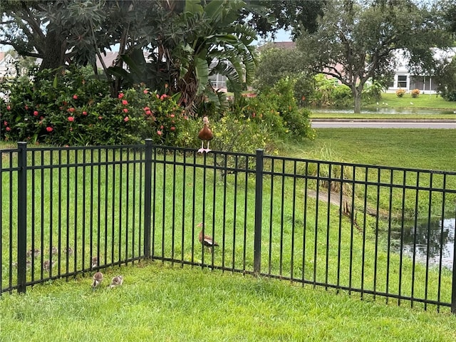 view of gate featuring a yard