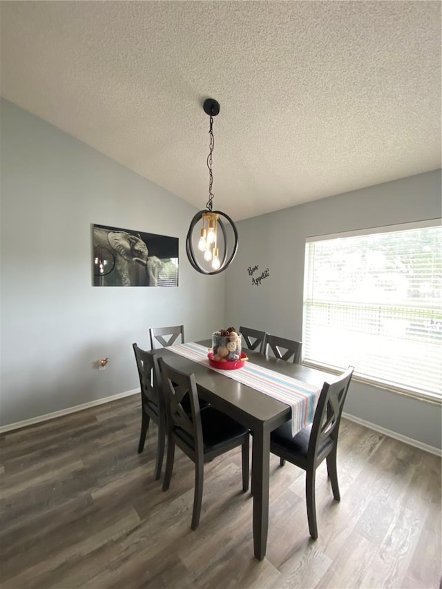 dining space featuring a chandelier, a textured ceiling, and hardwood / wood-style flooring