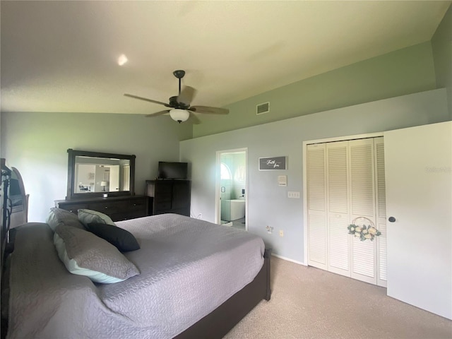 carpeted bedroom with ceiling fan, vaulted ceiling, and a closet