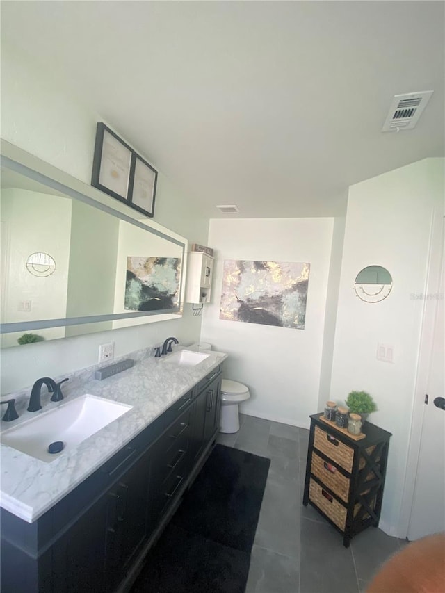 bathroom featuring tile patterned flooring, vanity, and toilet