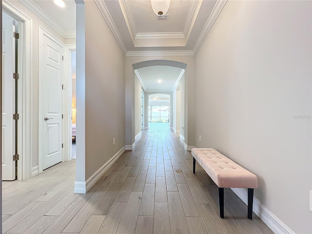 hallway featuring light wood-type flooring and crown molding