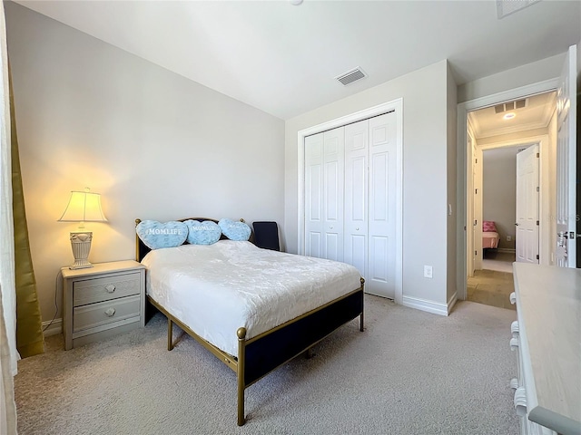 bedroom featuring light colored carpet and a closet