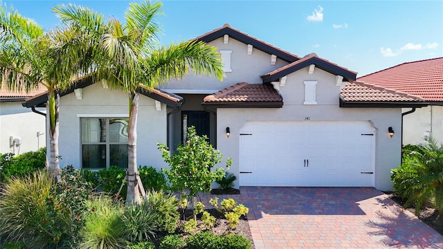 mediterranean / spanish-style home with a garage