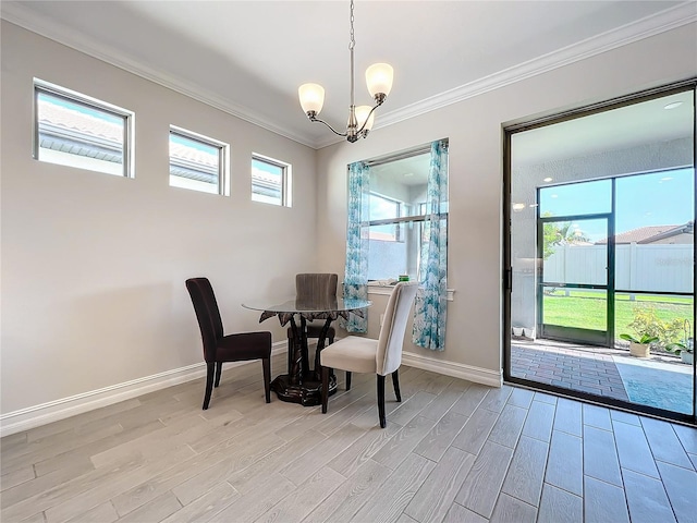 dining space with crown molding, light hardwood / wood-style flooring, and a chandelier