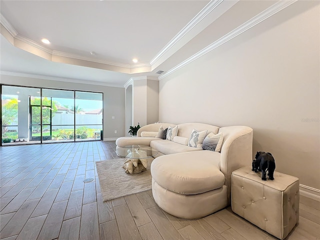 living room featuring ornamental molding and light hardwood / wood-style flooring