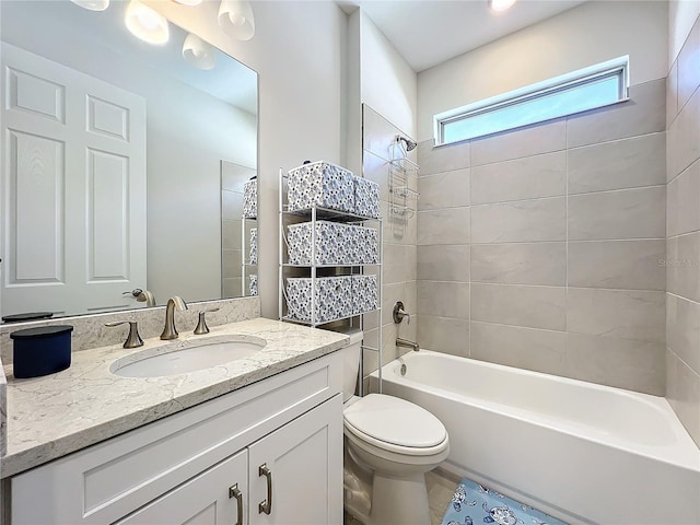 full bathroom with tiled shower / bath combo, vanity, and toilet