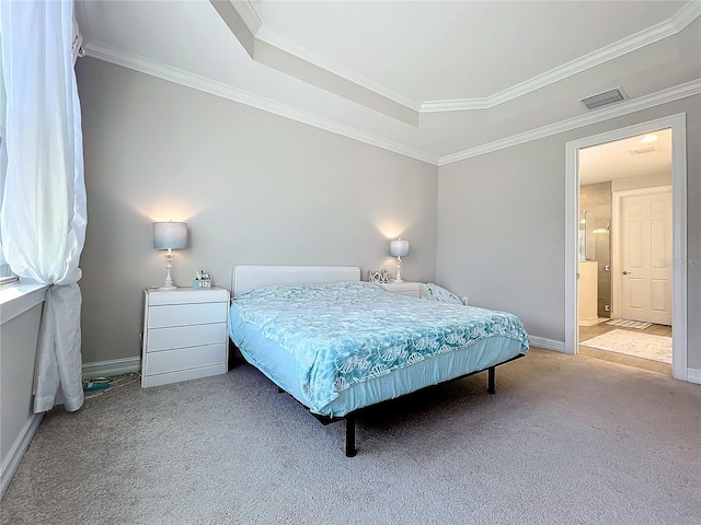 carpeted bedroom featuring a raised ceiling, ensuite bath, and ornamental molding