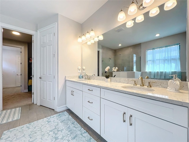 bathroom featuring vanity, a shower with door, and hardwood / wood-style flooring