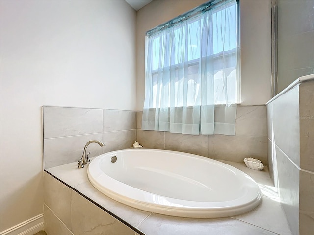 bathroom featuring tiled tub