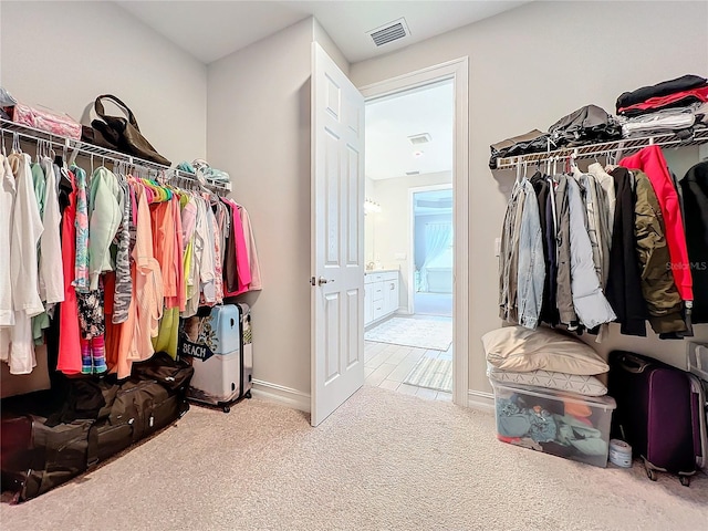 spacious closet featuring carpet floors