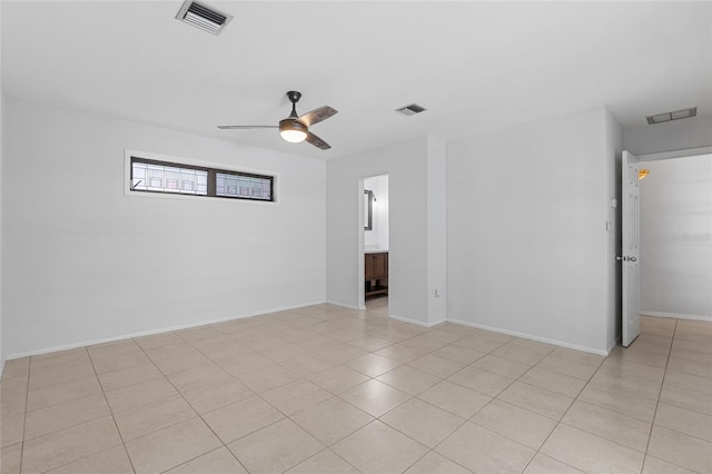 tiled spare room with ceiling fan