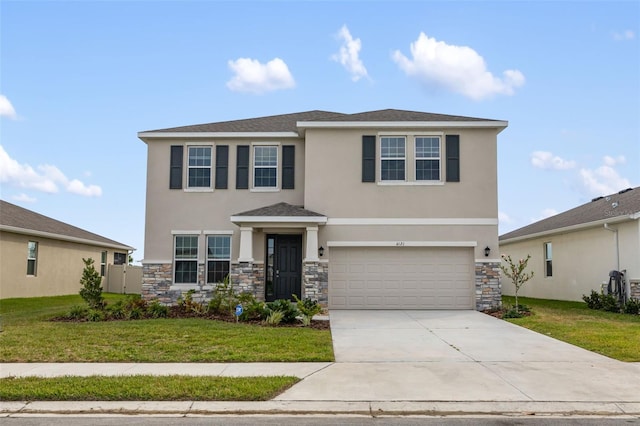 view of front of home featuring a front yard and a garage