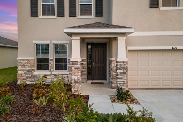 exterior entry at dusk with a garage