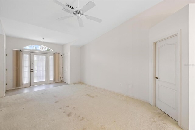 empty room featuring light carpet, ceiling fan, and french doors