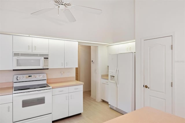 kitchen featuring light hardwood / wood-style floors, white appliances, ceiling fan, and white cabinets