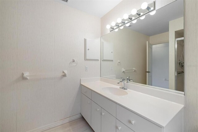 bathroom with vanity and a shower