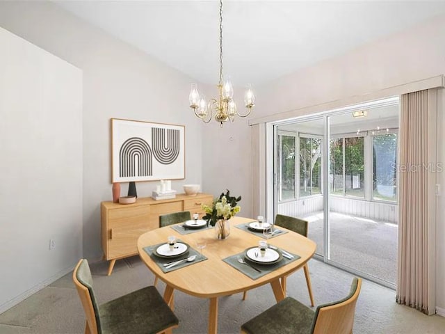 carpeted dining space featuring lofted ceiling and a notable chandelier