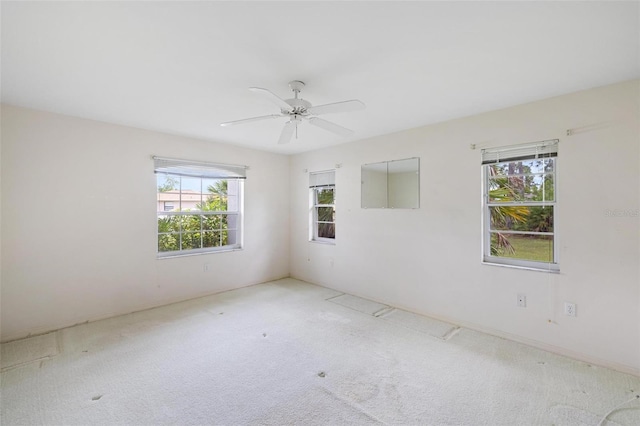 empty room with ceiling fan and carpet