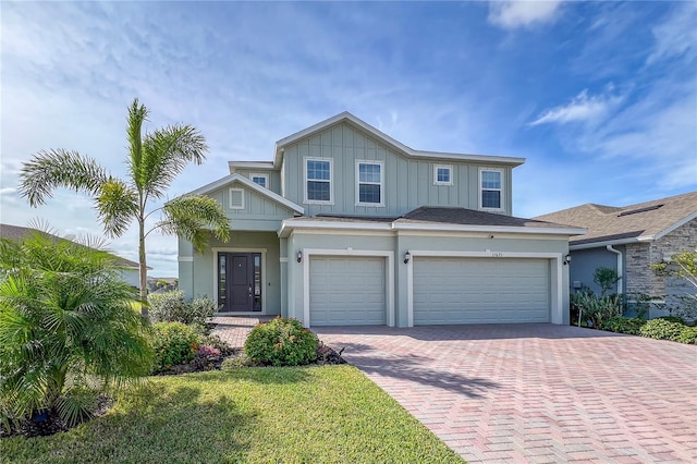 view of front of home with a front yard and a garage