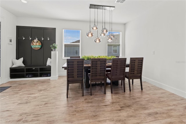 dining area with a notable chandelier and light wood-type flooring