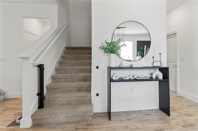 stairway with hardwood / wood-style flooring