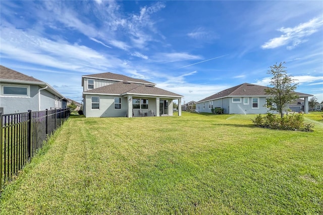 back of house with a yard