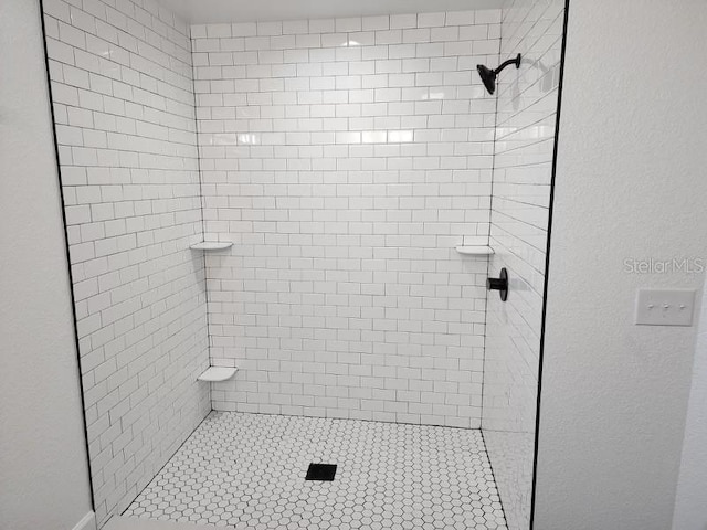 bathroom with tiled shower