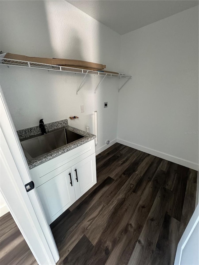 washroom with cabinets, sink, dark wood-type flooring, and electric dryer hookup