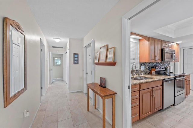 hall with crown molding and sink