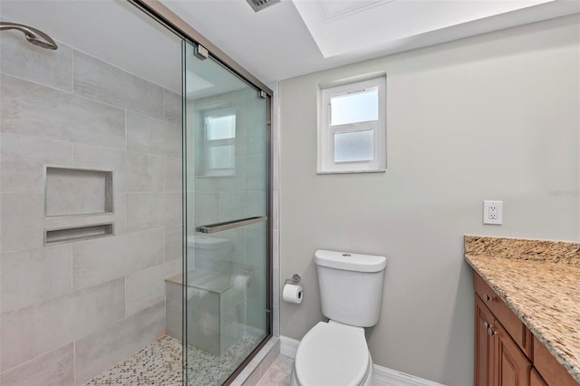 bathroom with vanity, toilet, and a shower with shower door