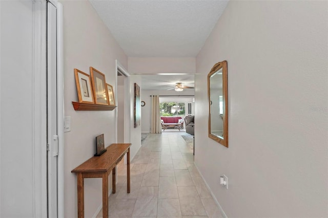 corridor featuring a textured ceiling