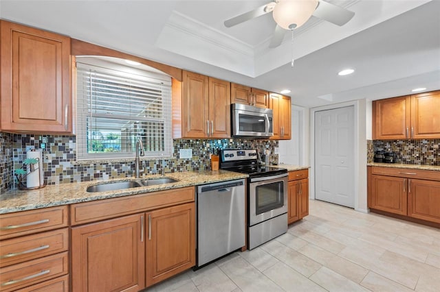 kitchen with backsplash, appliances with stainless steel finishes, crown molding, and sink