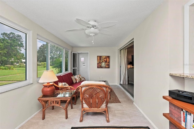 sunroom / solarium featuring ceiling fan